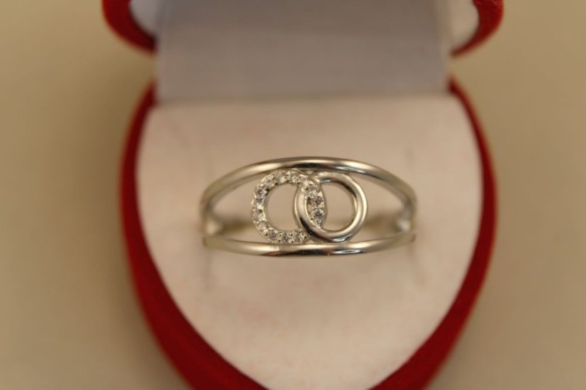 Prsteň- dva kruhy medzi obručou-číre zirkóny-rhodium-striebro
